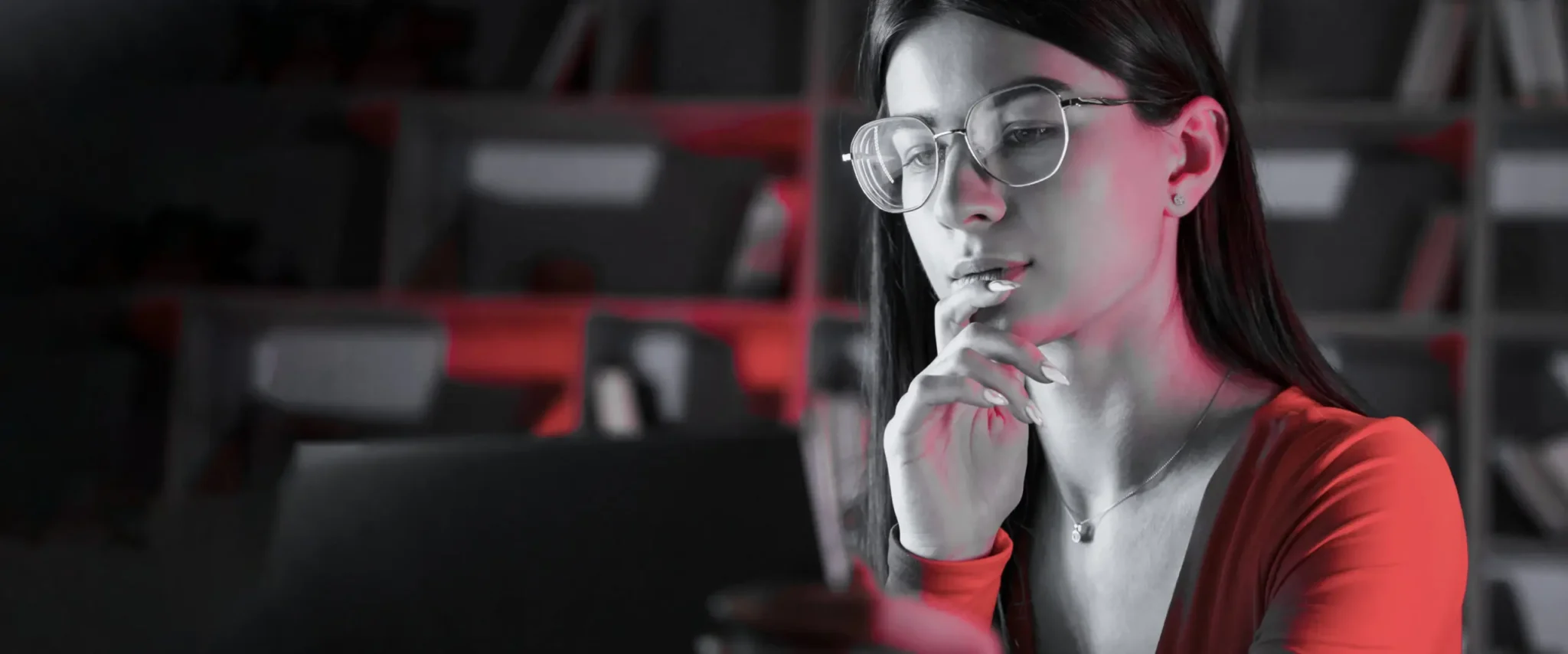Joven mujer atractiva con gafas mirando la pantalla del ordenador mostrando el crecimiento orgánico del SEO.